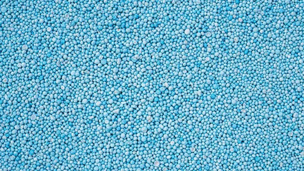 cropped-stock-photo-pattern-blue-urea-fertiliser-can-use-for-background-447307228.jpg
