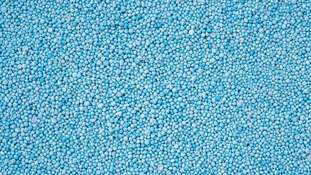 cropped-stock-photo-pattern-blue-urea-fertiliser-can-use-for-background-447307228.jpg